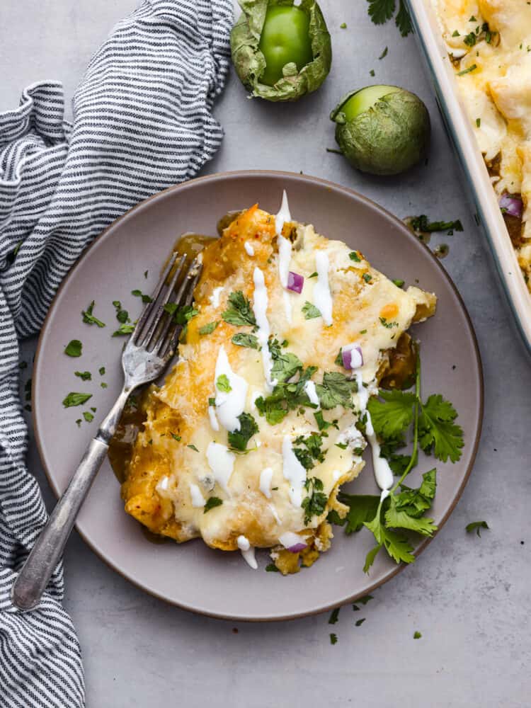 Enchiladas suizas served in a gray plate.