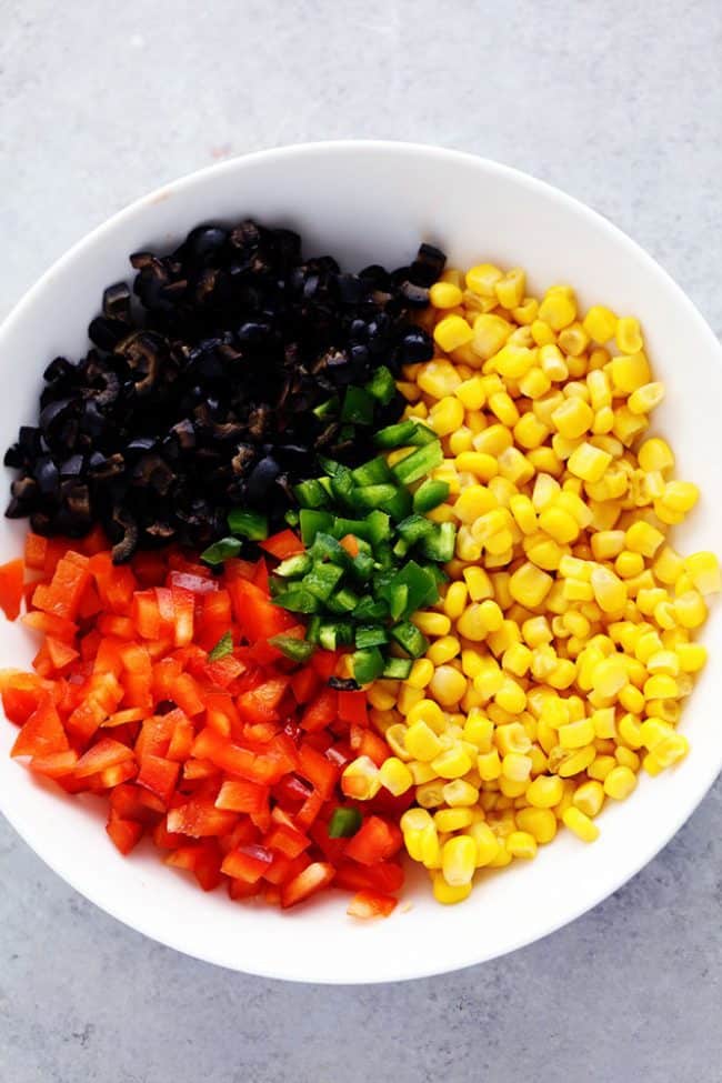 Ingredients for Creamy Ranch Dip in a white bowl. 