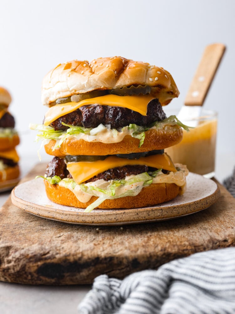 A homemade Big Mac burger on a stoneware plate.