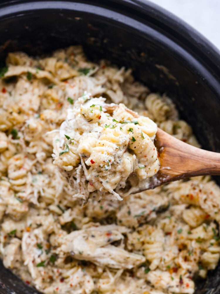 Closeup of a spoonful of crockpot parmesan garlic chicken pasta.