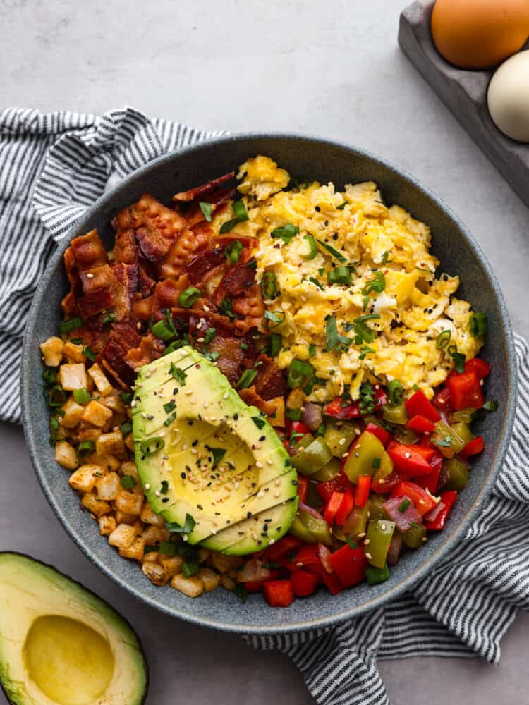 Top view of a breakfast bowl with sliced avocado on top. 