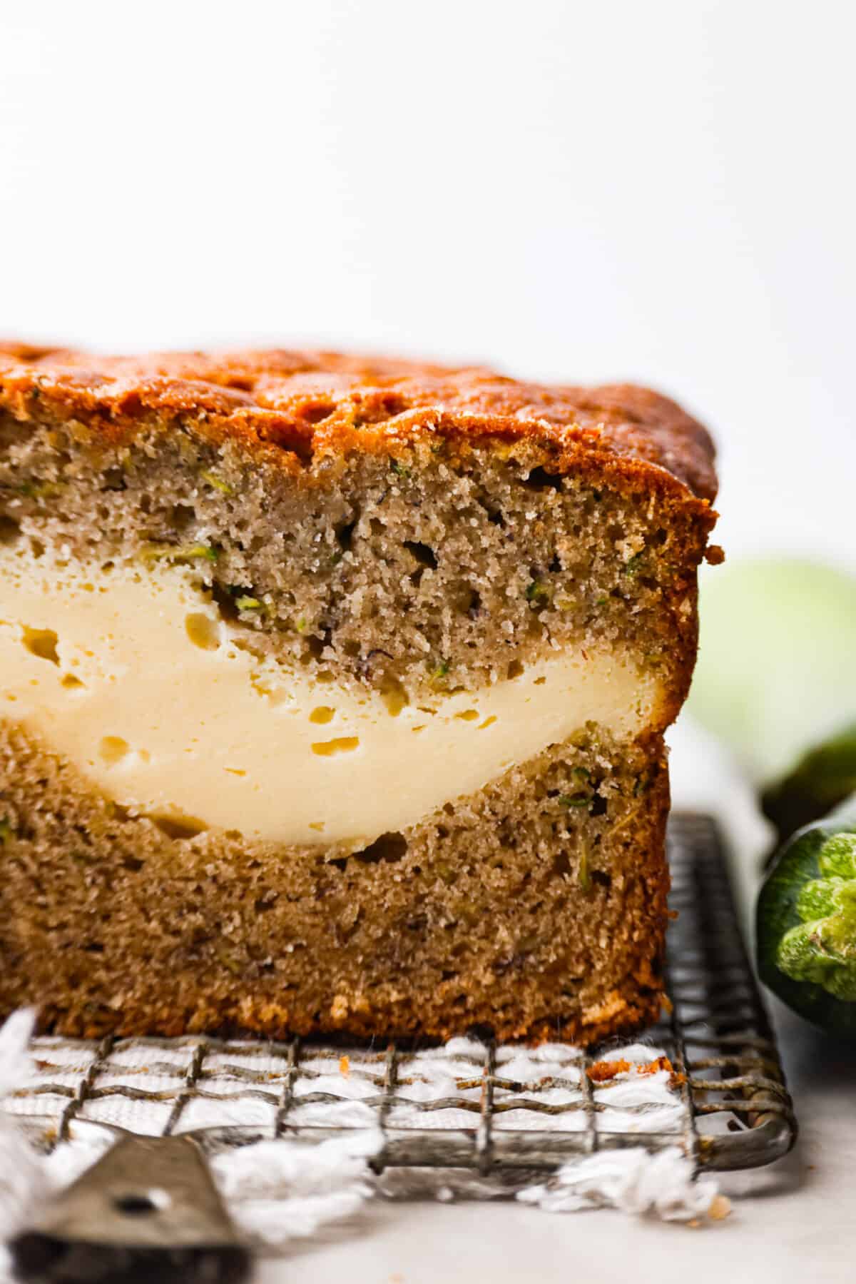 Closeup of a slice of cream cheese banana zucchini bread.