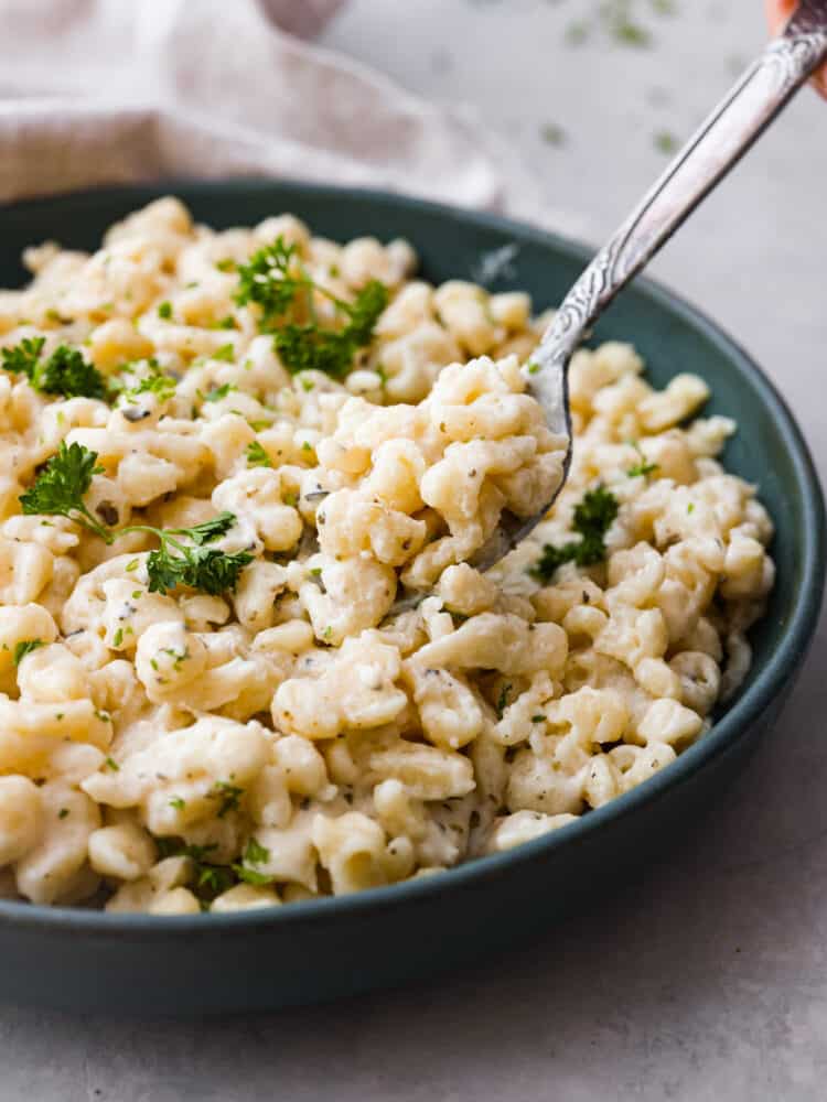 Picking up a spoonful of spätzle.