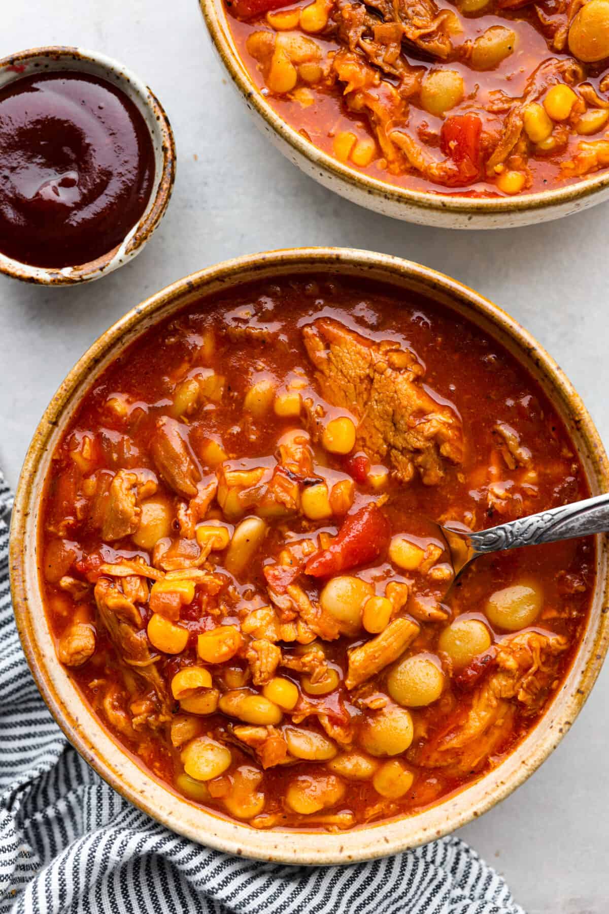 Top-down view of Brunswick stew served in a stoneware bowl.