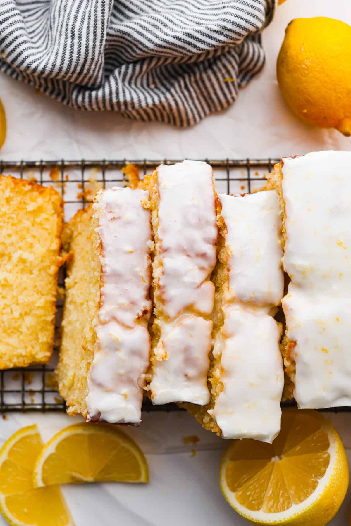 The top view of slices Starbucks lemon loaf on a cooling rack with a white glaze on top. 