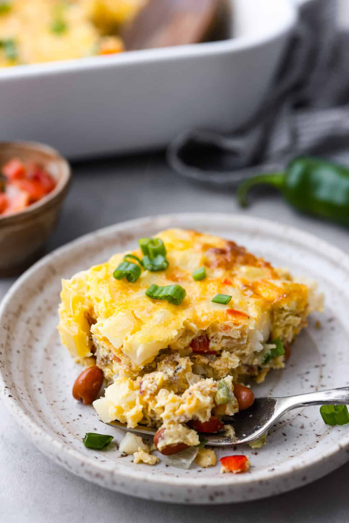 A slice of the breakfast bake with a bite taken out of it 