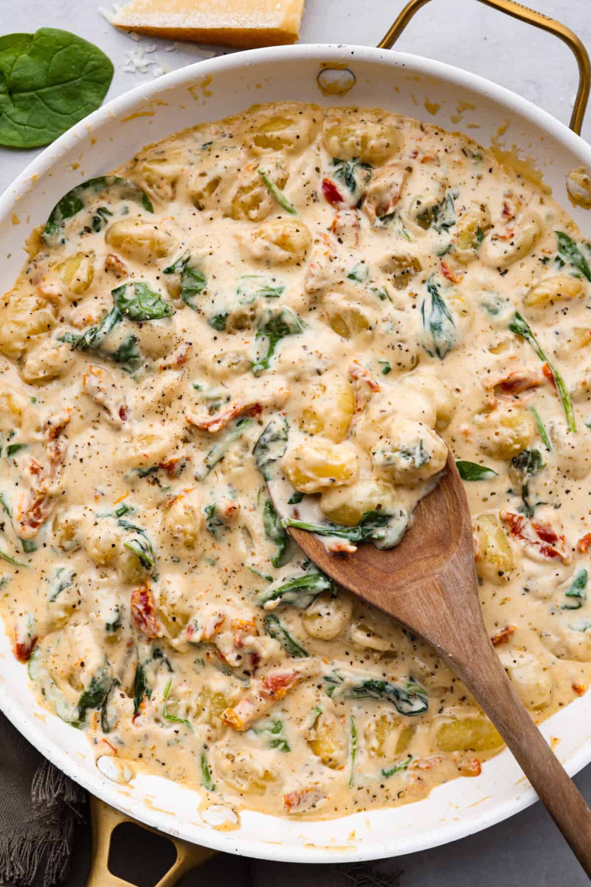 Tuscan parmesan gnocchi in a white skillet.