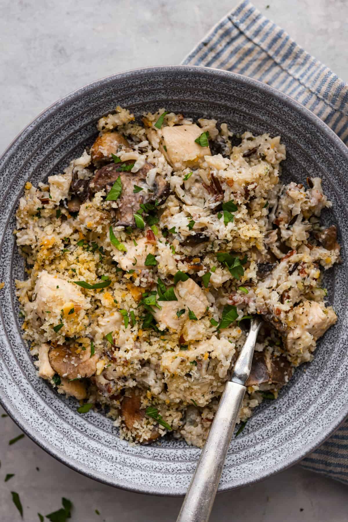 A serving of the casserole in a gray stoneware dish.