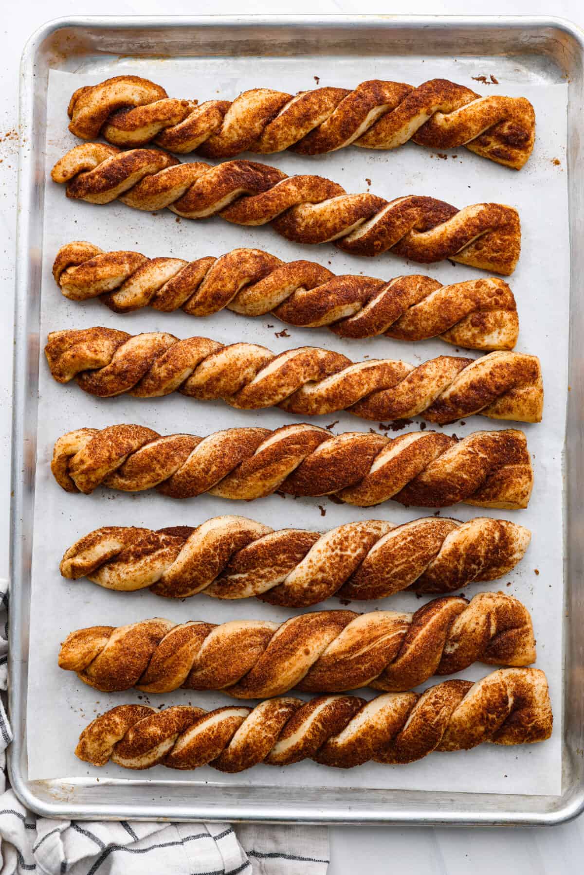 Top view of the bread twists baked on a baking sheet.