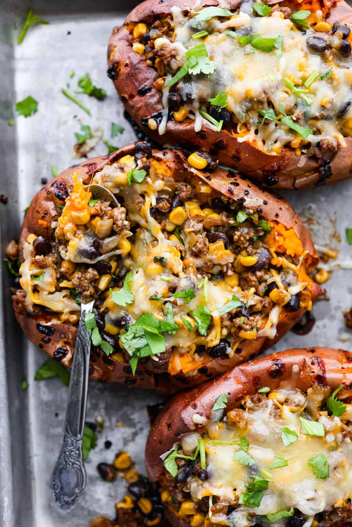 Top-down view of 3 stuffed sweet potatoes.