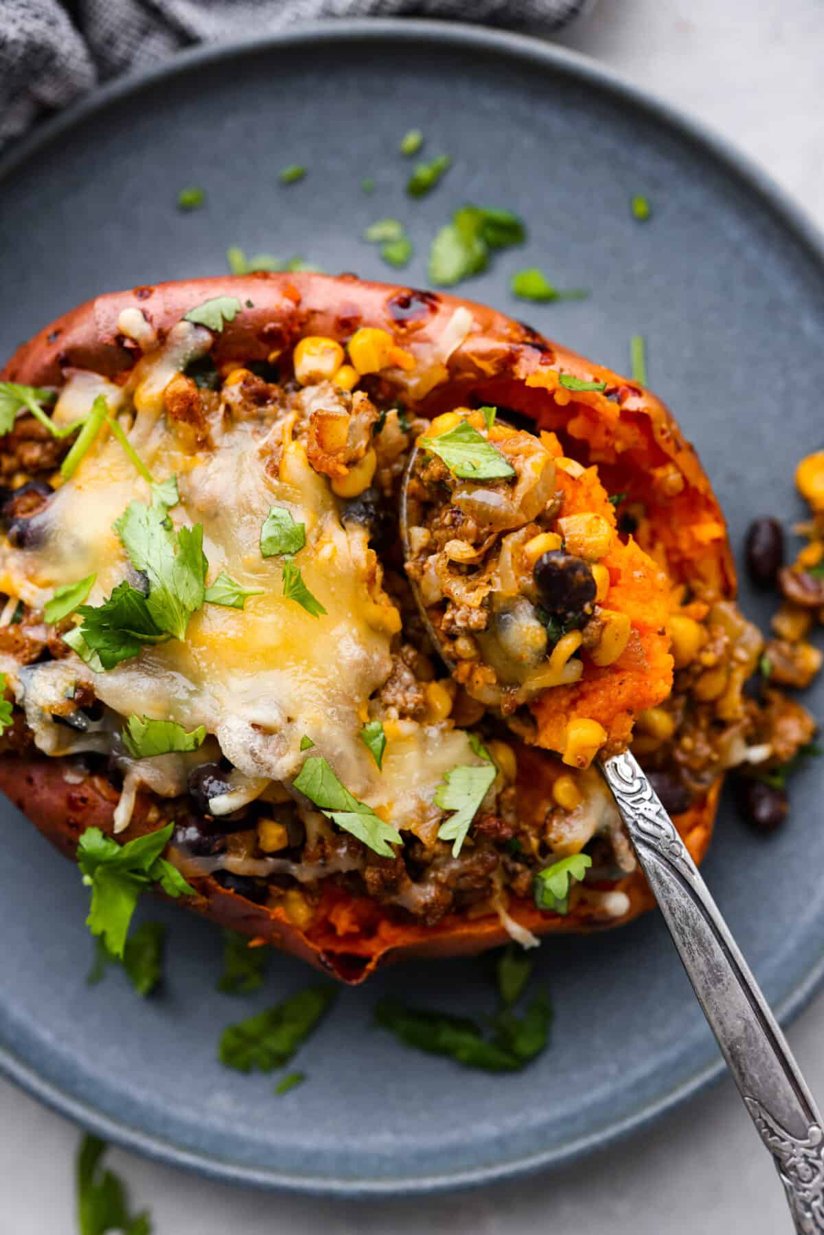 Taking a spoonful of roasted sweet potato and the filling.