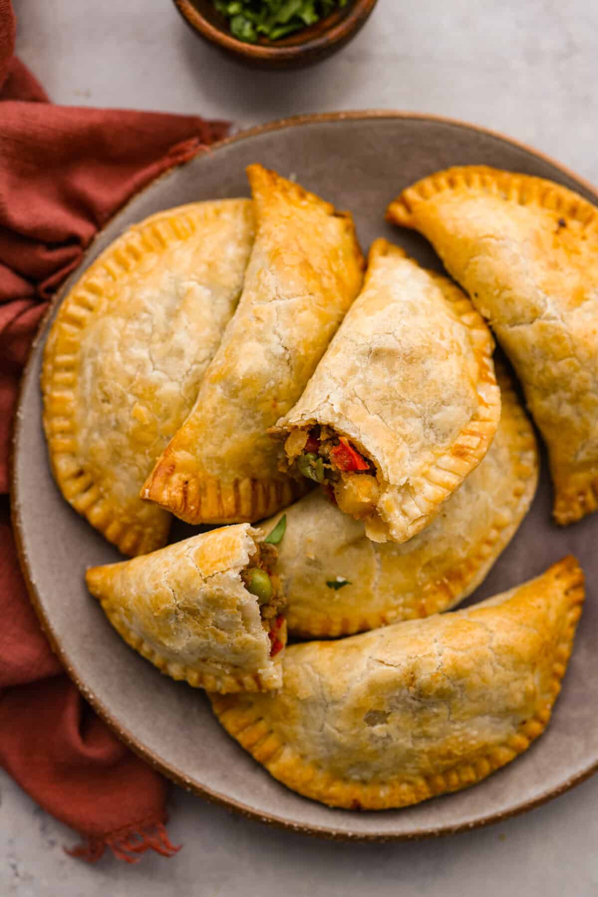 Top-down view of the empanadas on a serving dish.