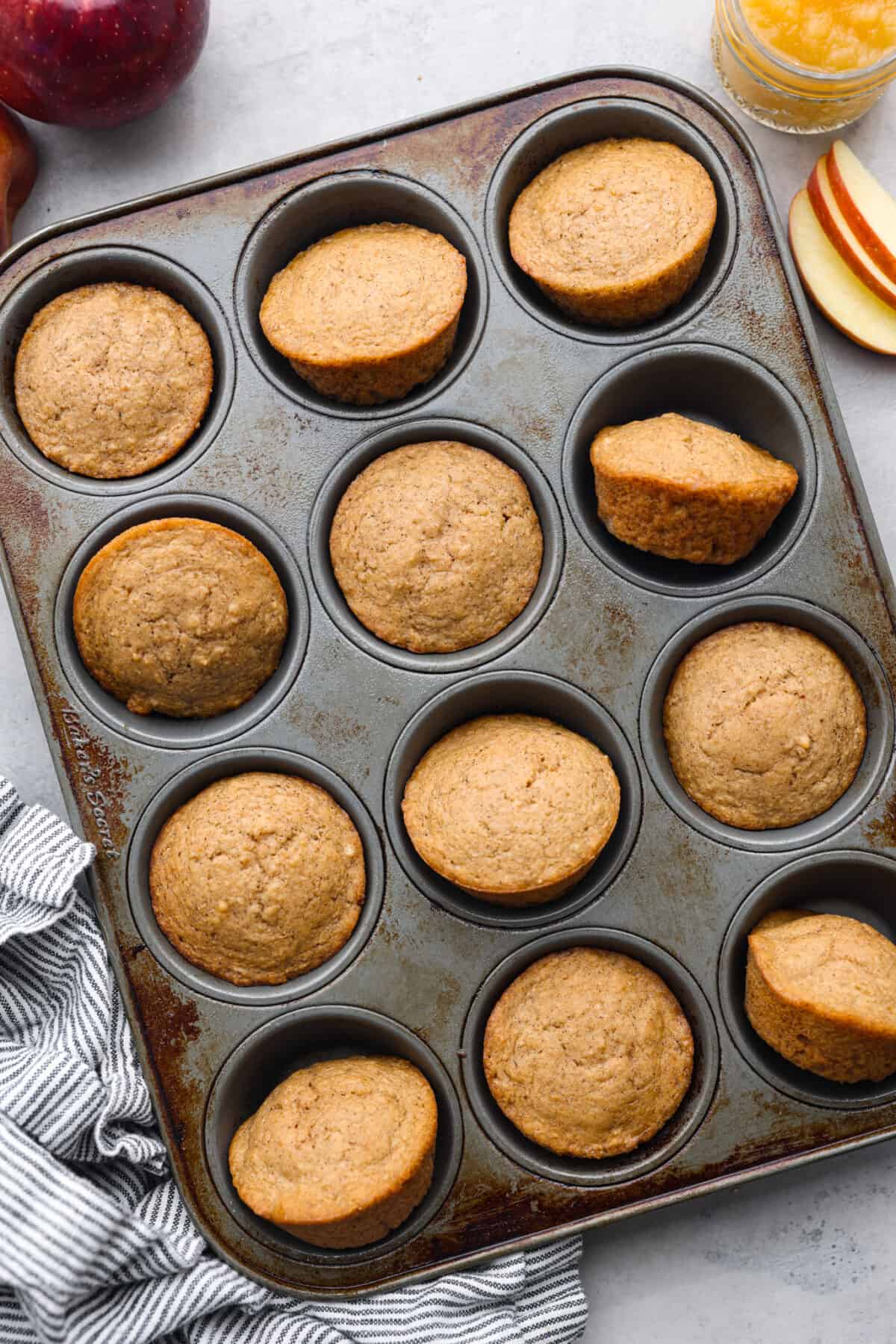 Top-down view of baked muffins in a muffin tin.