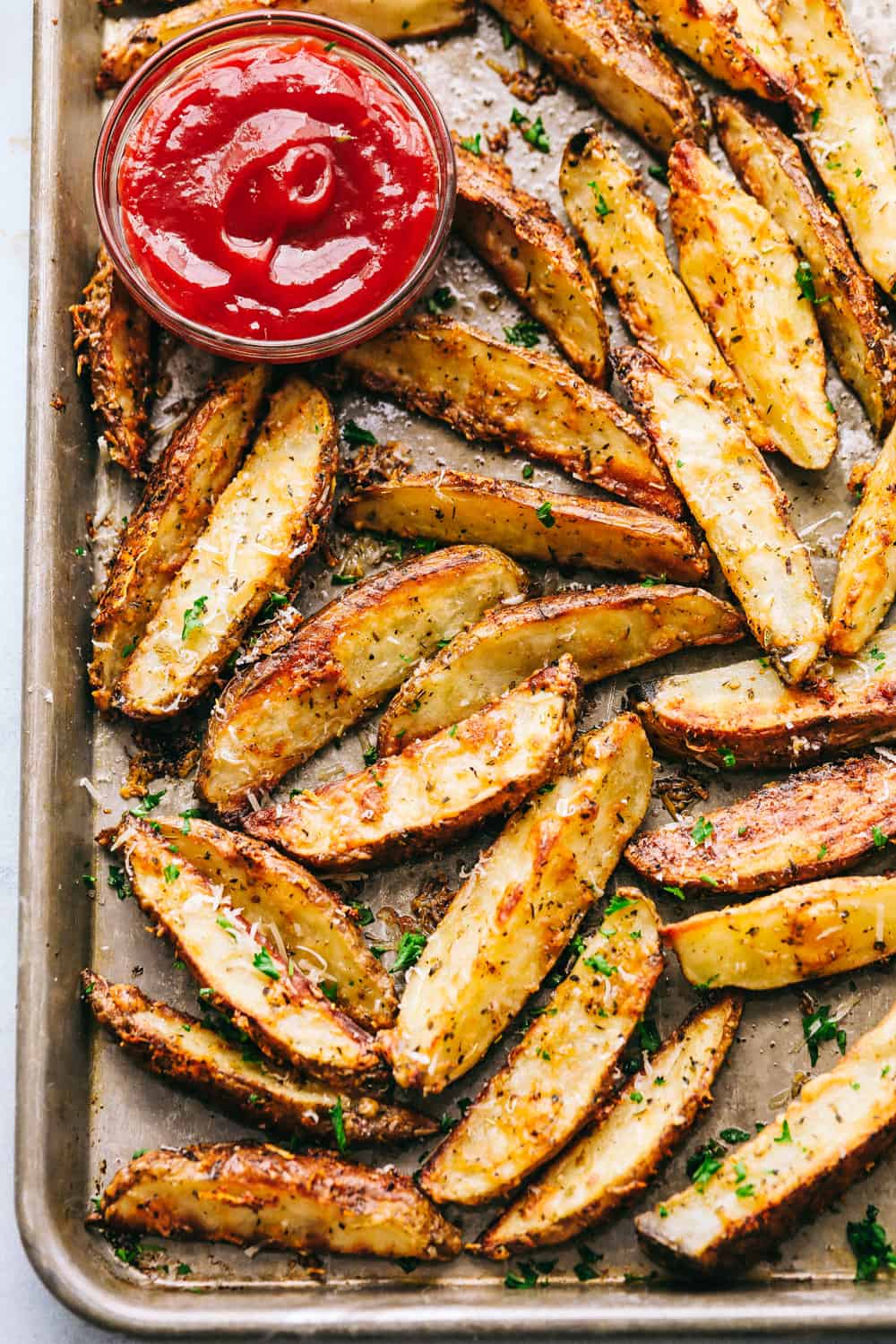 The cooked potato wedges on a baking sheet.