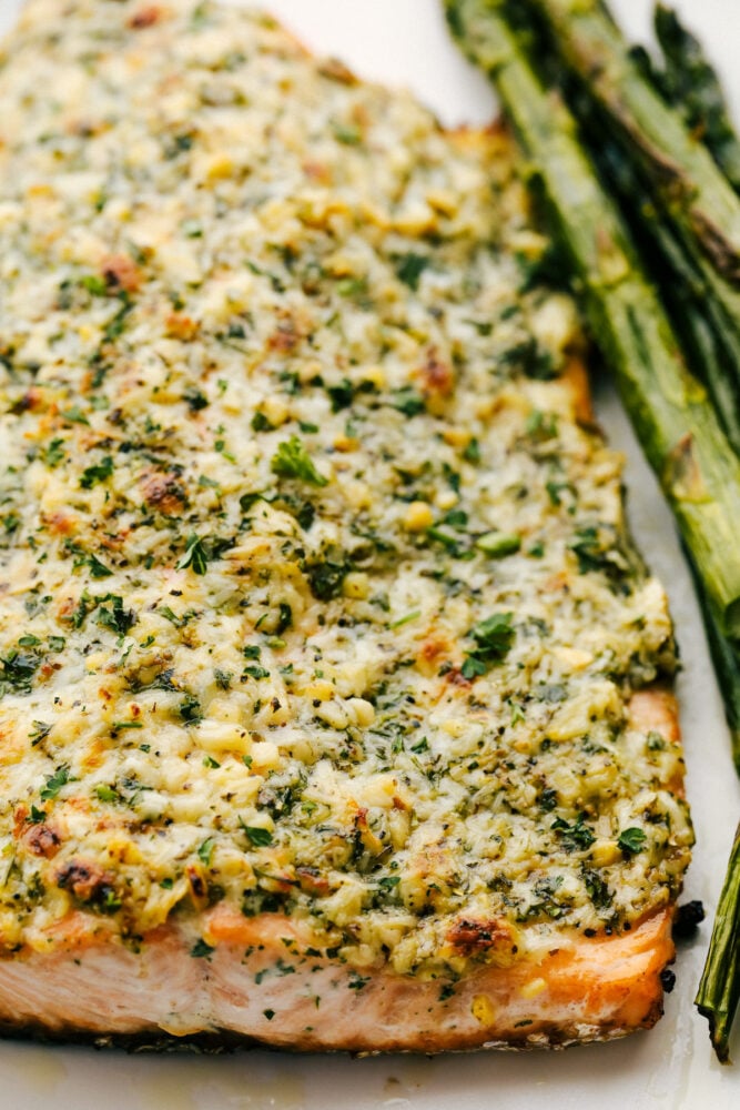 Salmon with parmesan and garlic on a platter.