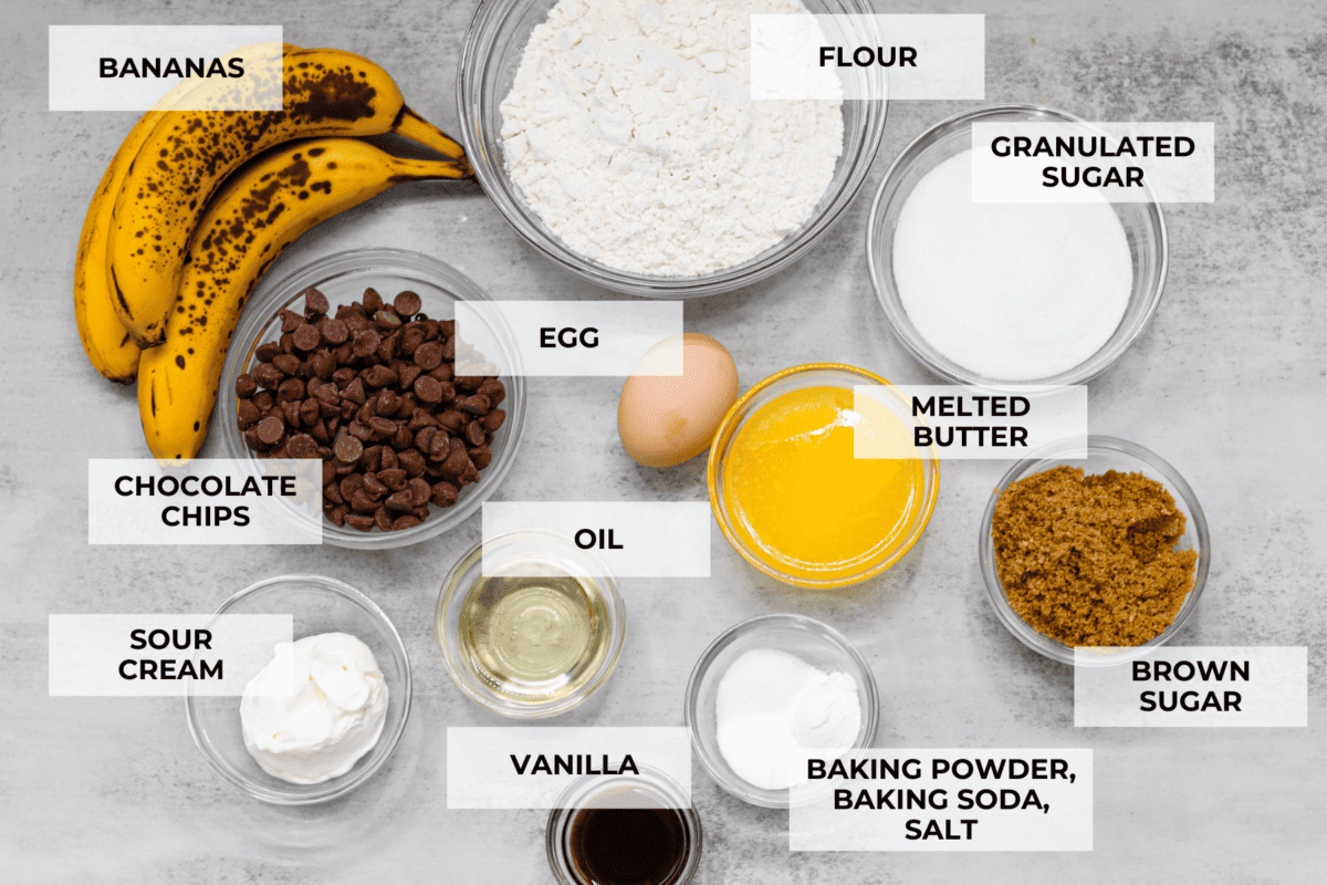 A top shot of ingredients for the muffins, all in glass bowls and labeled. 