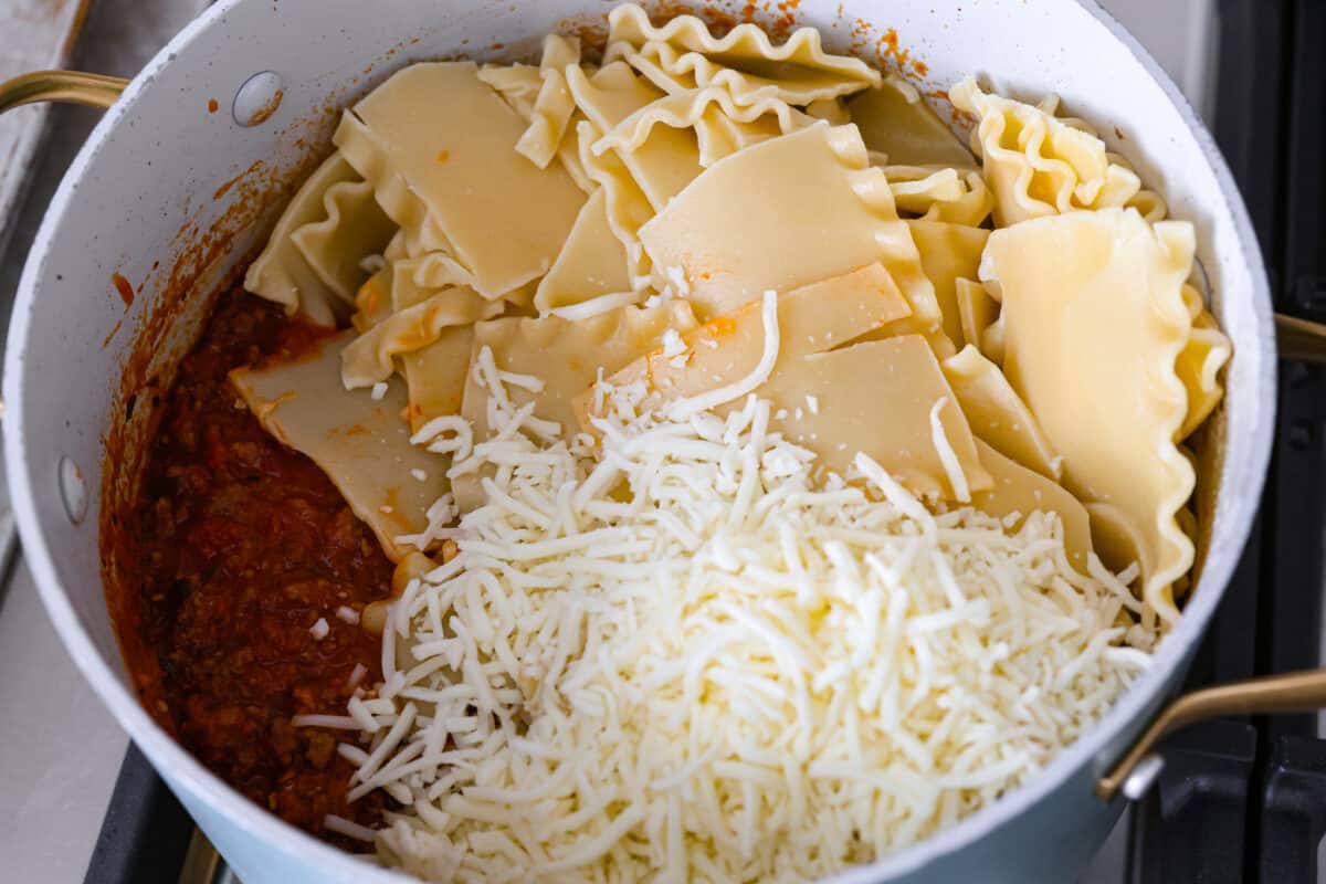 Noodles being added to a pot. 