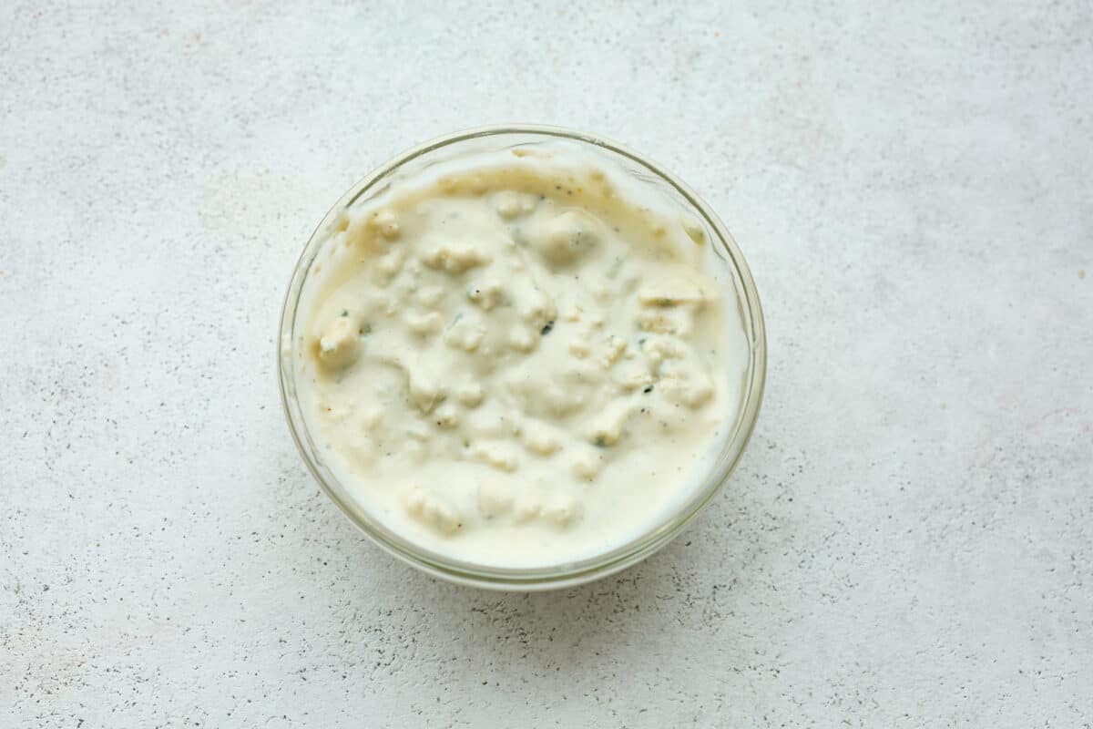 Overhead view of blue cheese dressing in a bowl. 