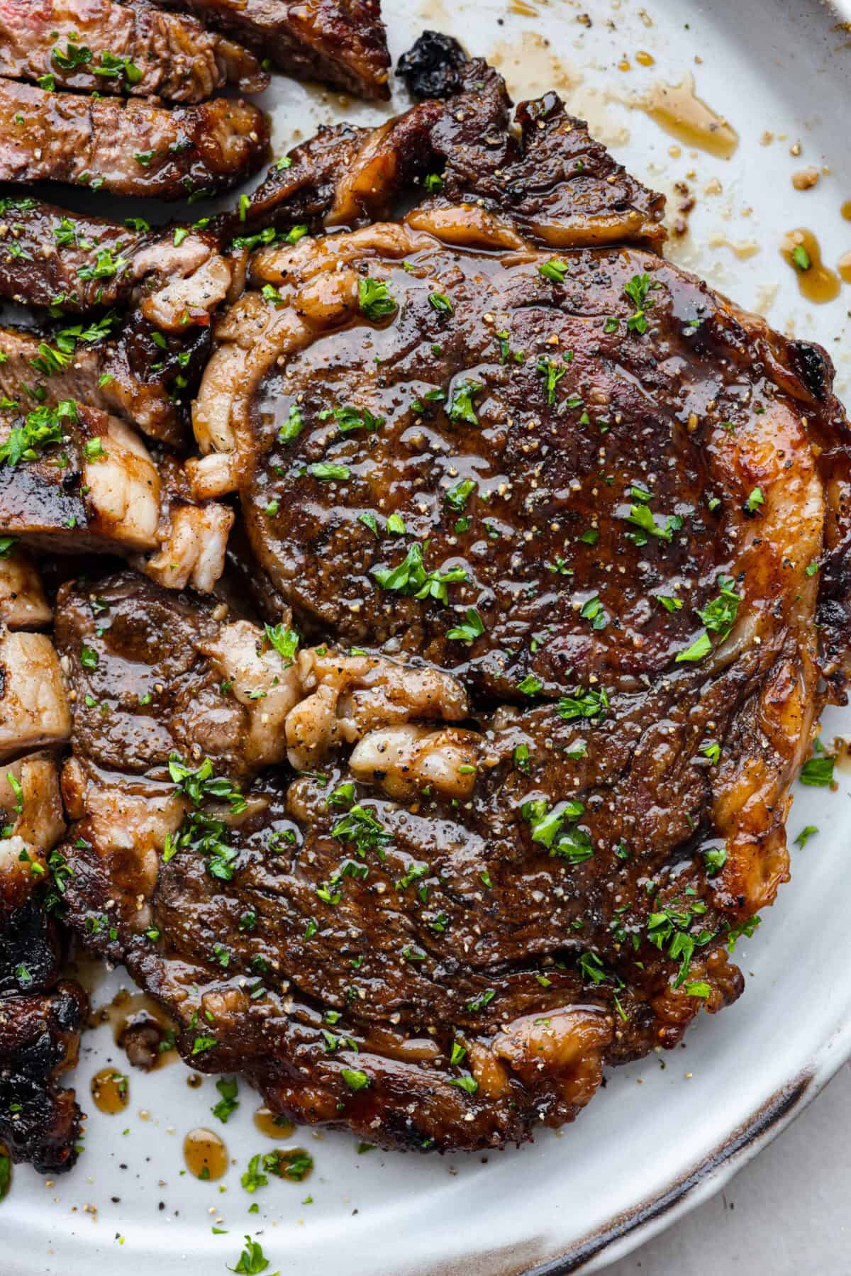 A close up of grilled bourbon steak on a plate. 